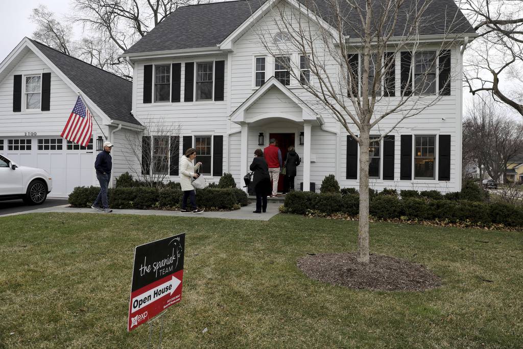 Several potential homebuyers arrive to look over a home for sale in Northbrook on March 30, 2022.