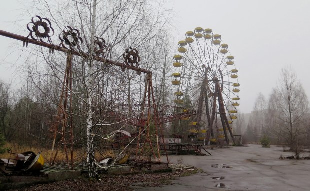 Swings and a ferris wheel remain in an abandoned amusement park of Pripyat, Ukraine. The park was scheduled to open on May 1, 1986, for the Soviet May Day celebrations. It never opened, as the Chernobyl disaster happened on April 26, 1986, a week before the opening. (Claudia Himmelreich/McClatchy DC/Tribune News Service via Getty Images)