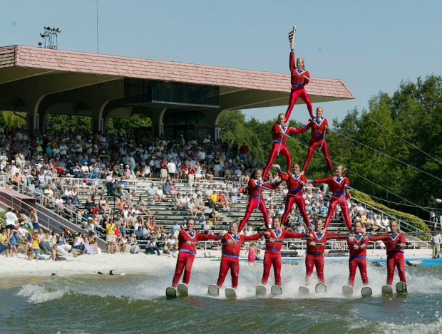 Members of the Cypress Gardens ski show perform a pyramid as they pass the grandstands during the last part of their final performance on the park's last day of operations on Sunday, April 13, 2003 in Winter Haven, Fla. The park reopened on Dec. 9, 2004. The new owners filed for Chapter 11 protection Monday Sept. 11, 2006. (AP Photo/File, Scott Audette, File)