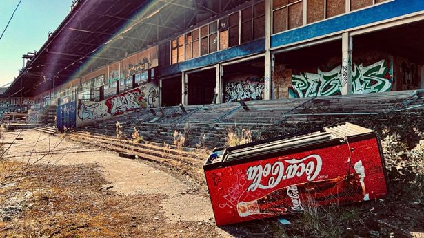An empty fridge next to old stands