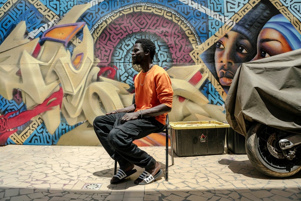 An artist is sitting in the schoolyard at RBS Akademya in the Golf Sud neighbourhood on the outskirts of Dakar, Senegal.
