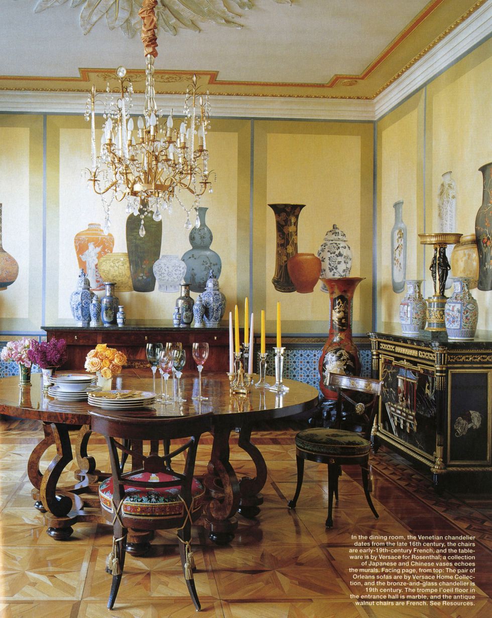 in the dining roomthe venetian chandelier dates from the late 16th century the chairs and early 19th century french and the tableware is by versace for rosenthal a collection of japanese and chinese vases echoes the murals
