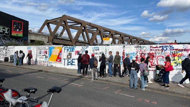 Activists re-daubing the graffiti wall with anti-Chinese slogans after the local authority had covered over the original “core values of Socialism” stunt (photo by a member of London’s Uyghur community). These comments were also painted out later.