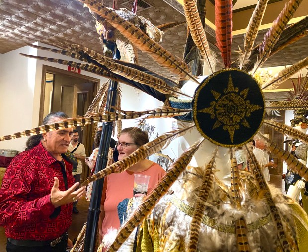 Local artist Mario Saucedo talks about his costume creations during the opening of The Reflective Art of Indigenous People exhibit at the Vallejo Naval and Historical Museum on Saturday. (Chris Riley/Times-Herald)
