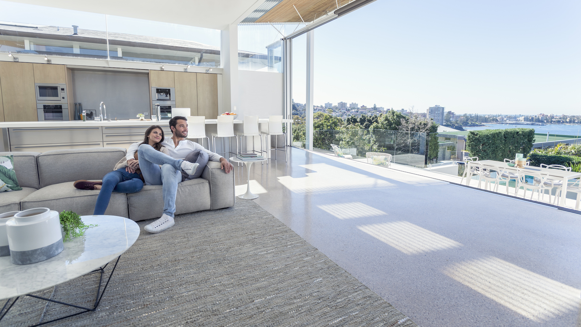 Couple sitting in a modern open plan house.