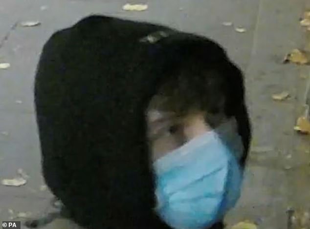 A still taken from CCTV footage has been released in a bid to track down the suspect, who is pictured with hood up and wearing a blue face mask