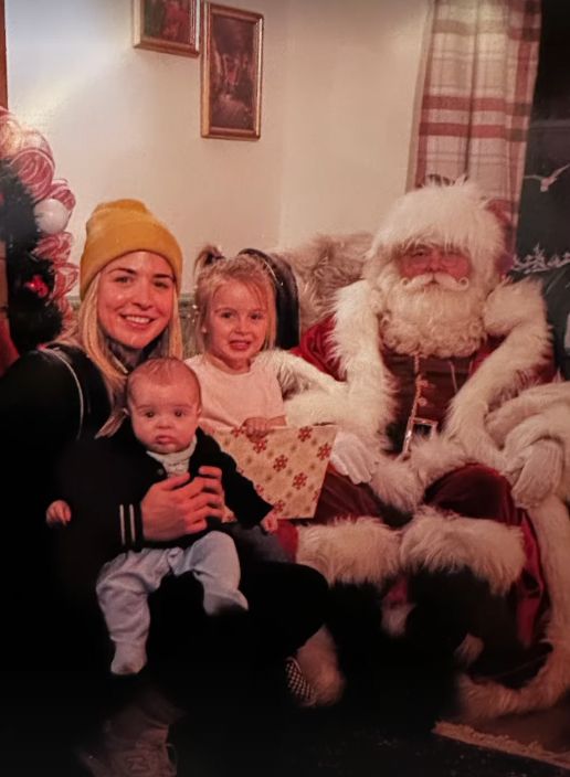 A family-of-three posing with Santa Claus