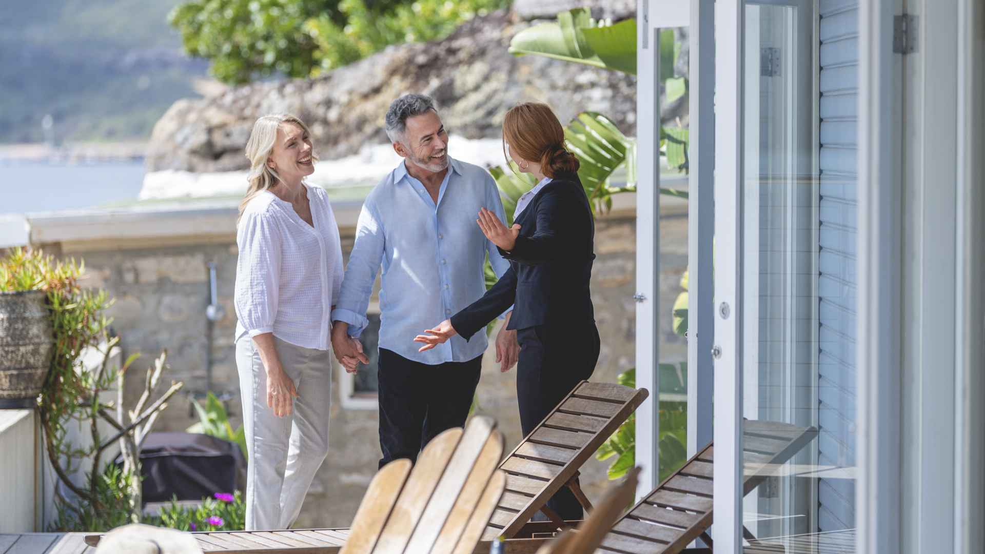 Real estate agent showing a mature couple a new house.