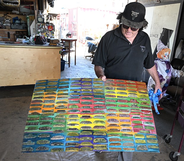 Artist Nicholas Fullerton shows the grill sheet that inspired him to create the new car mandala mural on Pennsylvania Street in Vallejo. (Chris Riley/Times-Herald)