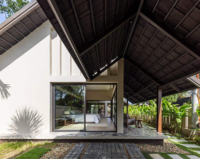 five intertwined gable roofs top pham huu son architects' h.a garden house in vietnam